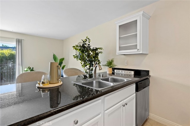 kitchen with glass insert cabinets, white cabinetry, dishwasher, and a sink