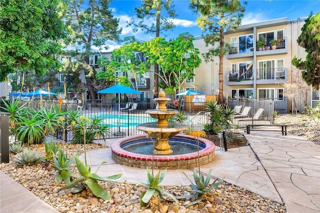 view of home's community featuring fence