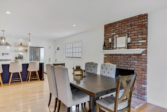 dining space featuring light wood-style floors and recessed lighting