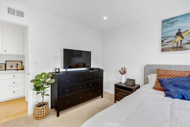 bedroom featuring light colored carpet, recessed lighting, and visible vents