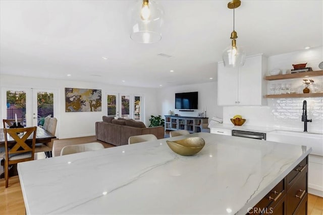 dining space with french doors, plenty of natural light, and recessed lighting