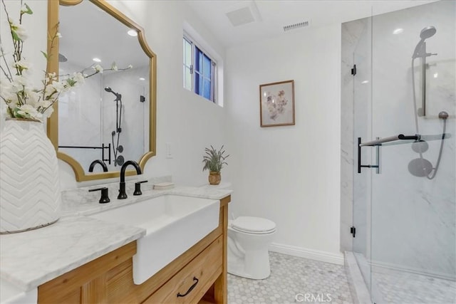 full bath featuring toilet, vanity, a marble finish shower, and visible vents