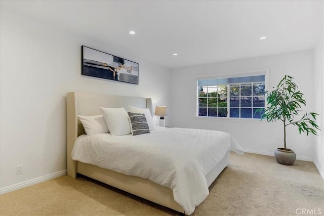 bedroom featuring recessed lighting, light carpet, and baseboards