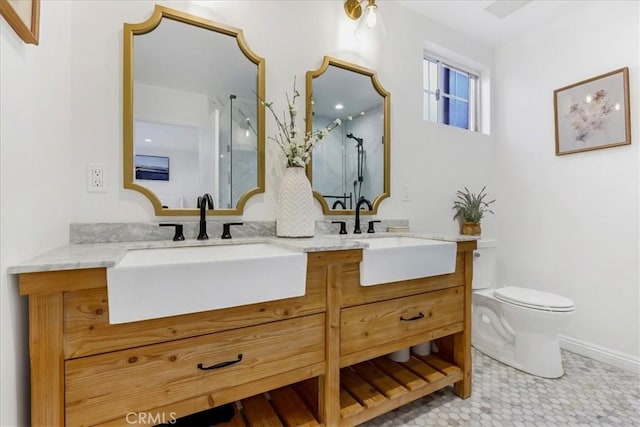 full bath with a sink, a shower stall, toilet, and double vanity