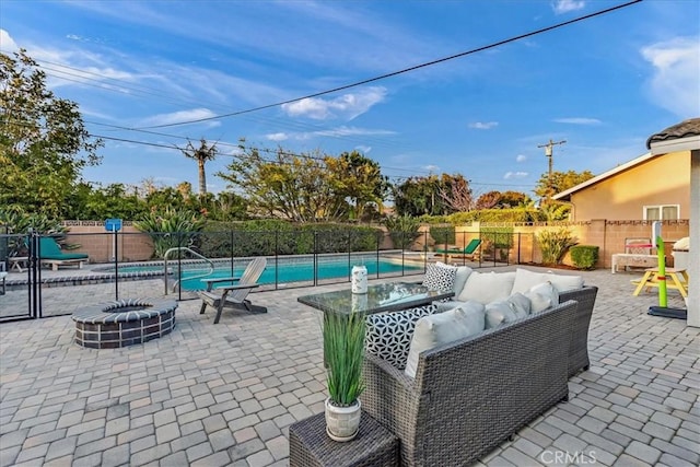 view of patio featuring an outdoor living space with a fire pit, a playground, a fenced backyard, and a fenced in pool