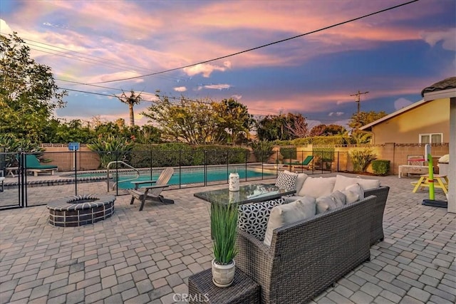 view of patio with an outdoor living space with a fire pit, a playground, a fenced backyard, and a fenced in pool