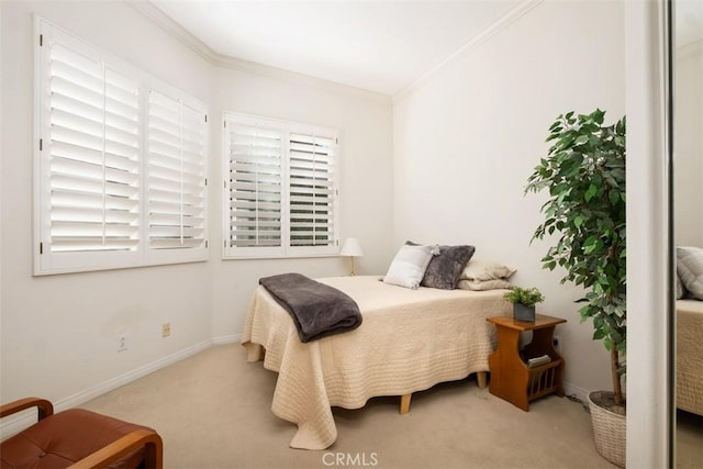 bedroom featuring light carpet, ornamental molding, and baseboards