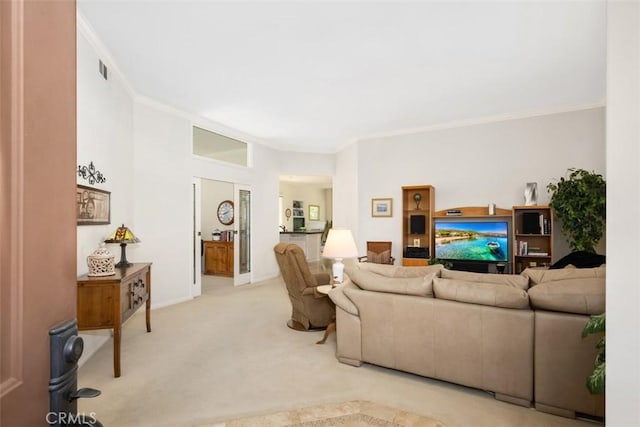 living area featuring crown molding, baseboards, visible vents, and light colored carpet