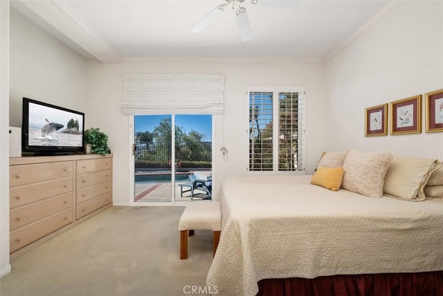 carpeted bedroom featuring access to outside, ceiling fan, and crown molding