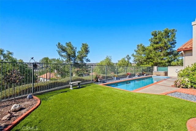 view of swimming pool featuring a yard, fence private yard, and a fenced in pool