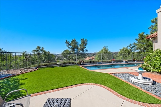 view of yard with a fenced backyard, a fenced in pool, and a patio