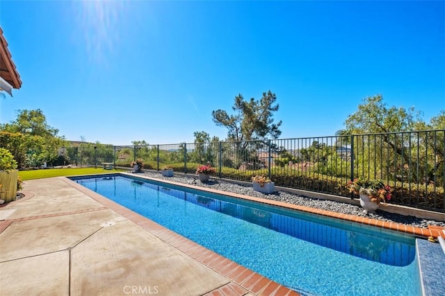 view of swimming pool with fence, a fenced in pool, and a patio