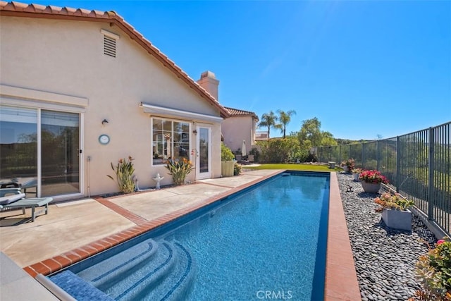 view of pool featuring a patio area, a fenced backyard, and a fenced in pool