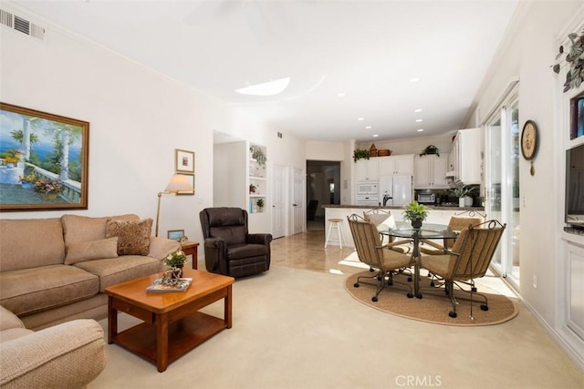 living room featuring recessed lighting, visible vents, and crown molding