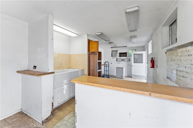 kitchen with a peninsula and white cabinetry