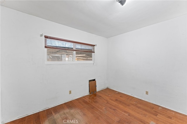 unfurnished room with wood-type flooring