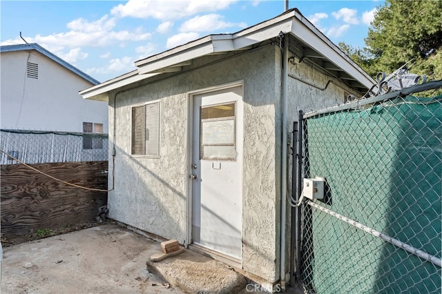 view of outbuilding featuring fence