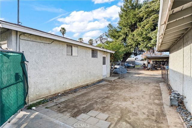 view of side of property featuring stucco siding