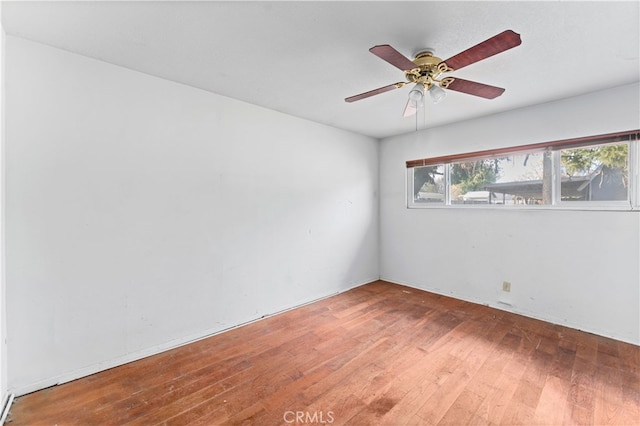 empty room featuring wood-type flooring and ceiling fan