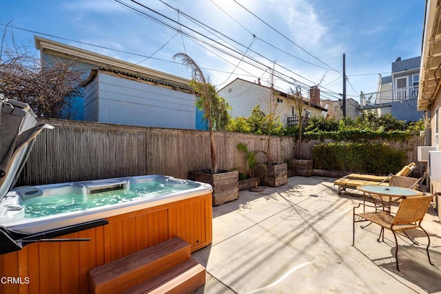 view of patio featuring a fenced backyard and a hot tub