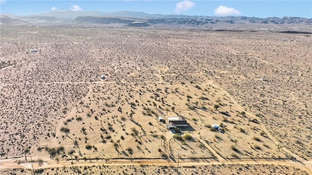 birds eye view of property featuring a desert view and a mountain view