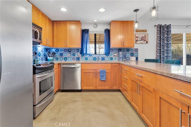 kitchen with appliances with stainless steel finishes, decorative light fixtures, a peninsula, light stone countertops, and backsplash