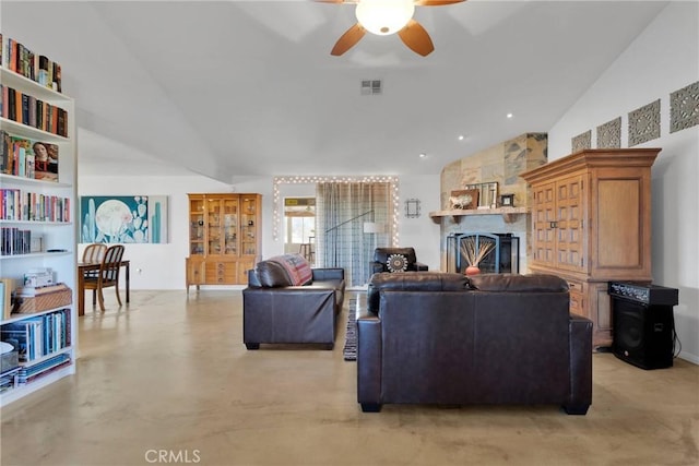 living room featuring finished concrete flooring, a fireplace, visible vents, and vaulted ceiling