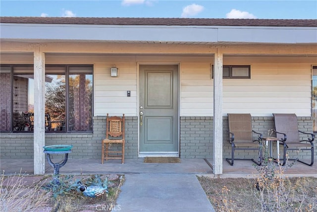 property entrance featuring brick siding