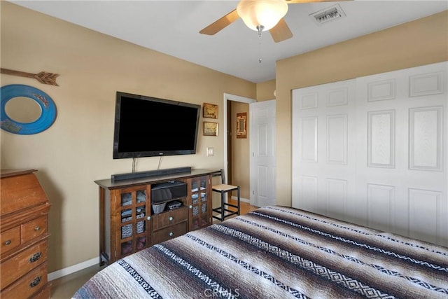 bedroom with a closet, visible vents, ceiling fan, and baseboards