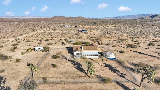 birds eye view of property with view of desert and a mountain view