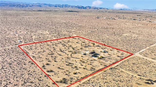 aerial view featuring view of desert and a mountain view