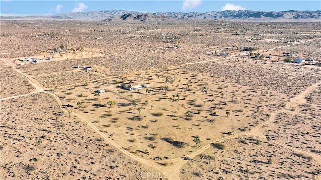 drone / aerial view with view of desert and a mountain view