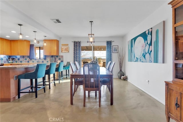 dining room featuring concrete flooring, recessed lighting, visible vents, and baseboards