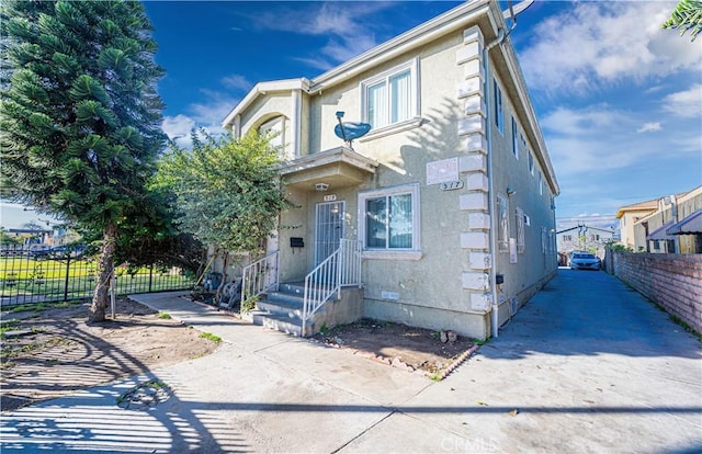 multi unit property with crawl space, fence, and stucco siding