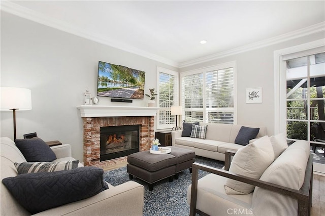 living area featuring ornamental molding, a brick fireplace, and wood finished floors