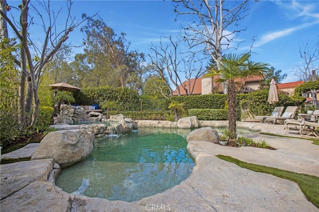 view of swimming pool featuring a fenced in pool, a patio area, and fence