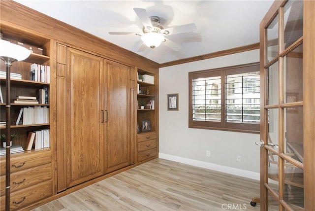 interior space with light wood finished floors, baseboards, and ornamental molding