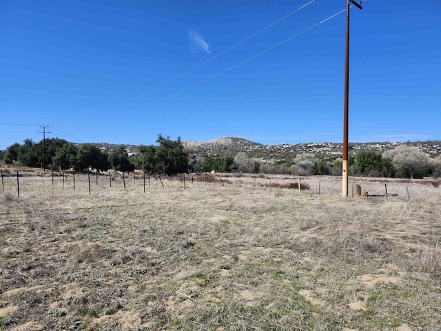 view of yard featuring a rural view and a mountain view