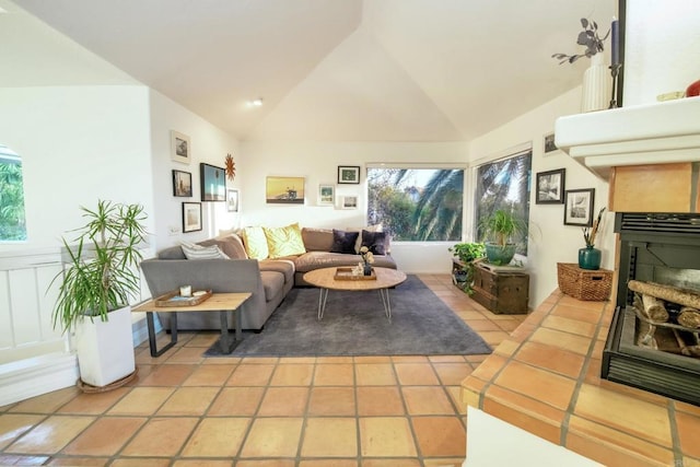 living area with high vaulted ceiling and light tile patterned flooring