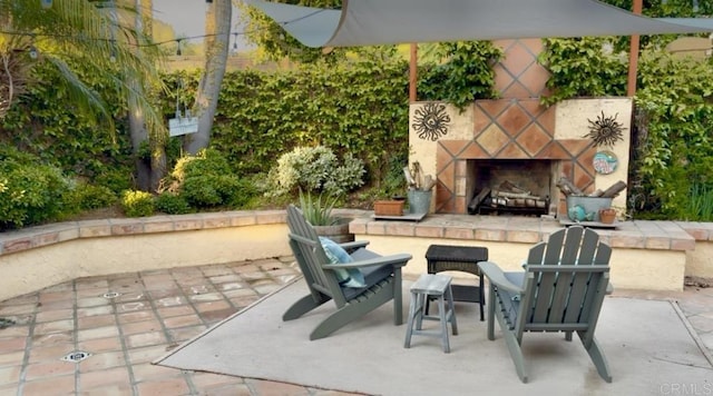 view of patio featuring an outdoor stone fireplace