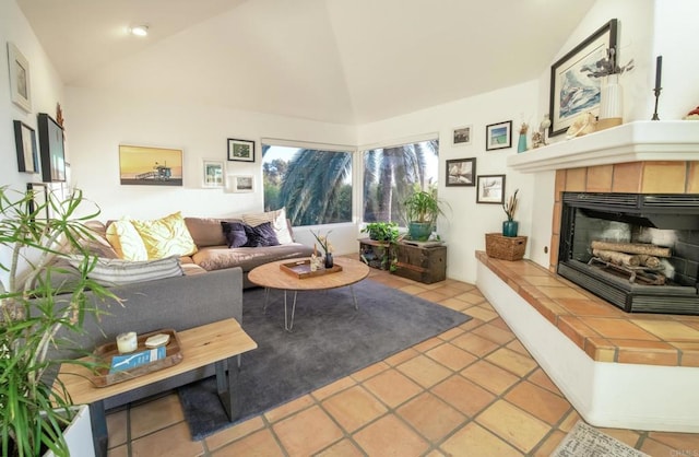 tiled living area featuring high vaulted ceiling and a fireplace