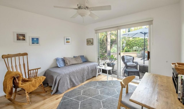 bedroom featuring ceiling fan, access to outside, light wood-type flooring, and a sunroom