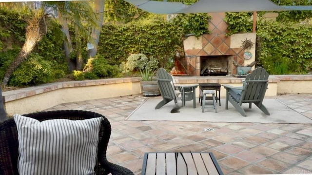 view of patio / terrace featuring an outdoor stone fireplace