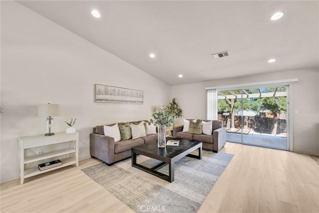 living area featuring light wood-style floors, lofted ceiling, visible vents, and recessed lighting