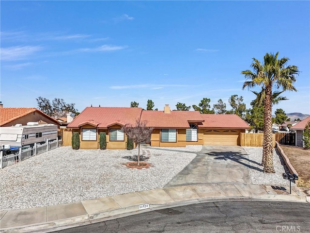 view of front of house with stucco siding, fence, and a tiled roof