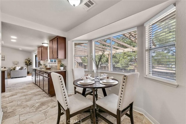 dining room featuring recessed lighting and baseboards