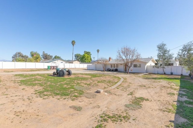 exterior space with driveway, an attached garage, and fence