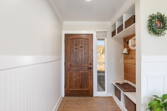 mudroom with a wainscoted wall, carpet floors, and crown molding