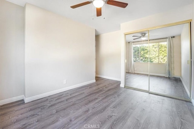 unfurnished room featuring baseboards and wood finished floors