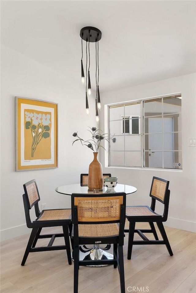 dining room with light wood finished floors and baseboards